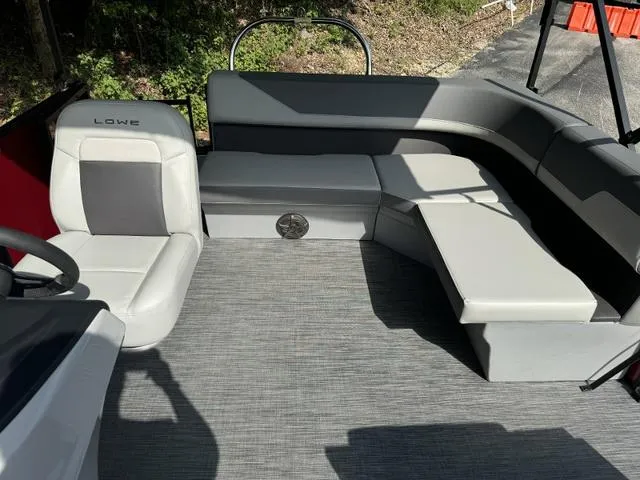 Slide: The Image of 2025 Lowe LS 170 boat interior with gray seating and steering wheel. - 8