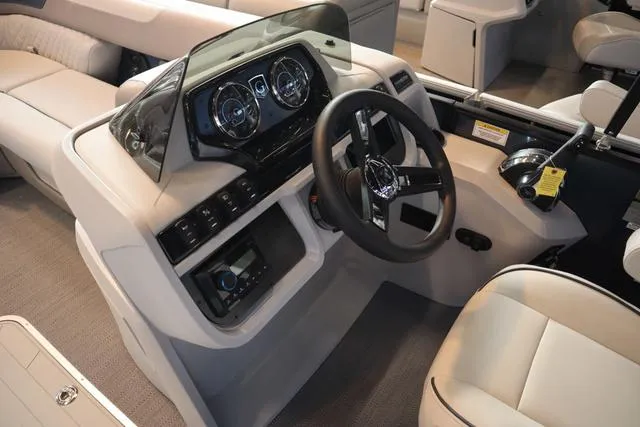 Slide: The Image of 2025 Godfrey Sweetwater 2286 SFL boat interior with steering console and captain's chair. - 12