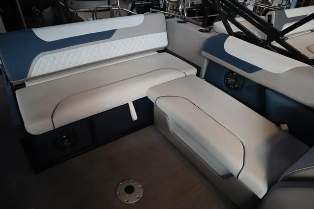 Slide: The Image of 2025 Godfrey Sweetwater 2286 SFL boat interior with beige and green seating. - 14