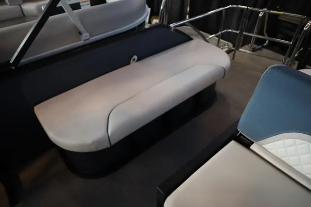 Slide: The Image of 2025 Godfrey Sweetwater 2286 SFL boat interior with beige seating and cup holders. - 15