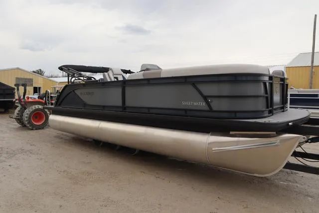 Slide: The Image of 2025 Godfrey Sweetwater 2286 SFL boat seating with cup holders and beige upholstery. - 25