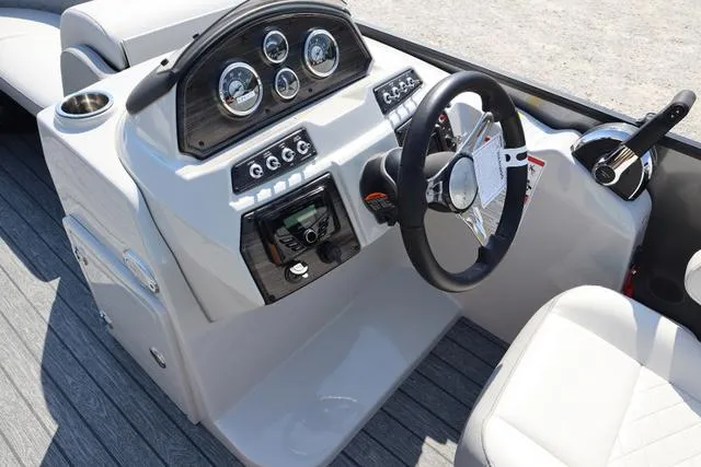 Slide: The Image of 2025 Lowe SS 230 WV boat dashboard with steering wheel and control panel. - 3