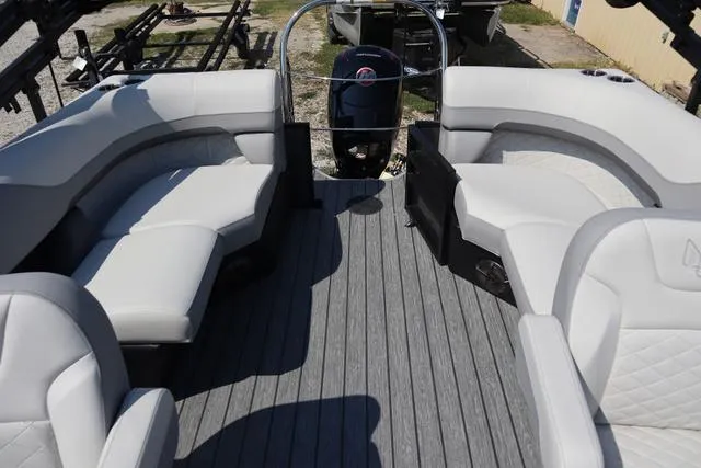 Slide: The Image of 2025 Lowe SS 230 WV pontoon boat interior with gray seating and flooring. - 4