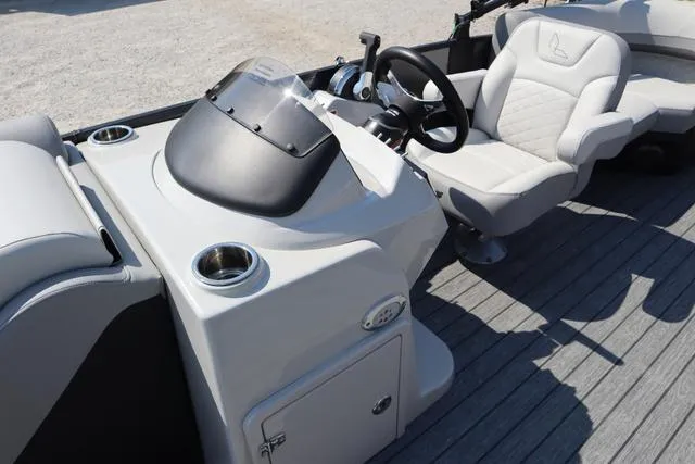 Slide: The Image of 2025 Lowe SS 230 WV boat interior with steering console and cushioned seating. - 6
