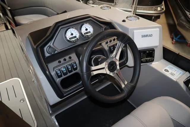 Slide: The Image of 2025 Bentley Pontoons Legacy 243 Swingback dashboard with steering wheel and control panel. - 18