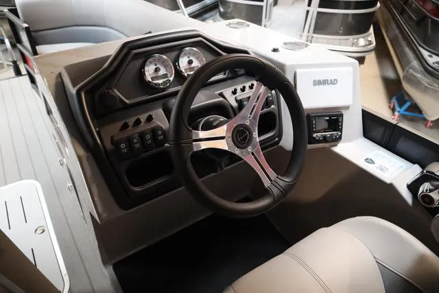 Slide: The Image of 2025 Bentley Pontoons Legacy 243 Swingback dashboard with steering wheel and controls. - 19