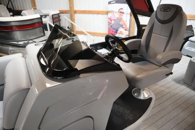 Slide: The Image of 2025 Bentley Pontoons Legacy 243 Swingback Ext. Triple Tube Pkg interior with steering console. - 23