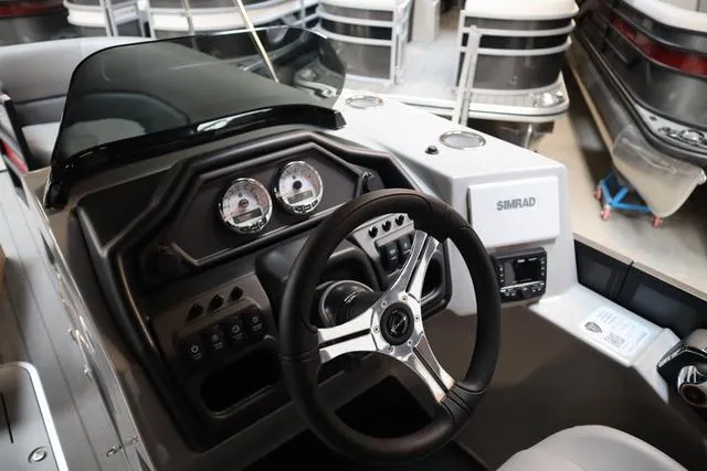 Slide: The Image of 2025 Bentley Pontoons Legacy 243 Swingback dashboard with steering wheel and controls. - 24