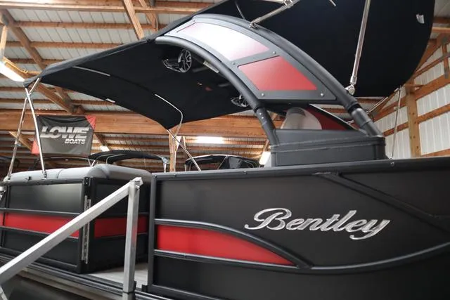 Slide: The Image of 2025 Bentley Pontoons Legacy 243 Swingback Ext. Triple Tube in a showroom. - 3
