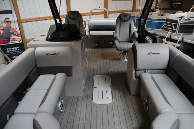Slide: The Image of 2025 Bentley Pontoons Legacy 243 Swingback interior with gray seating and modern design. - 5