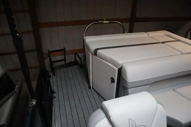 Slide: The Image of 2023 Lowe SS 210 Triple Tube Package interior with cushioned seating and sleek flooring. - 3