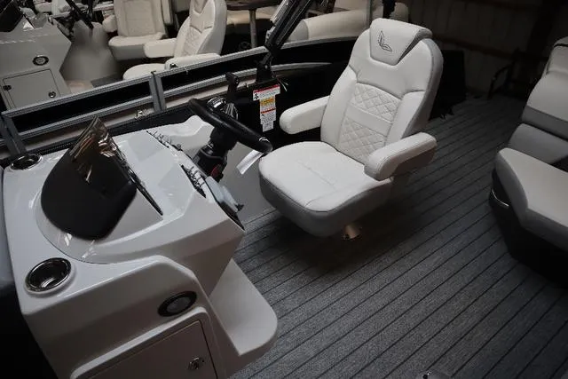 Slide: The Image of 2023 Lowe SS 210 Triple Tube Package boat interior with captain's chair and steering console. - 6