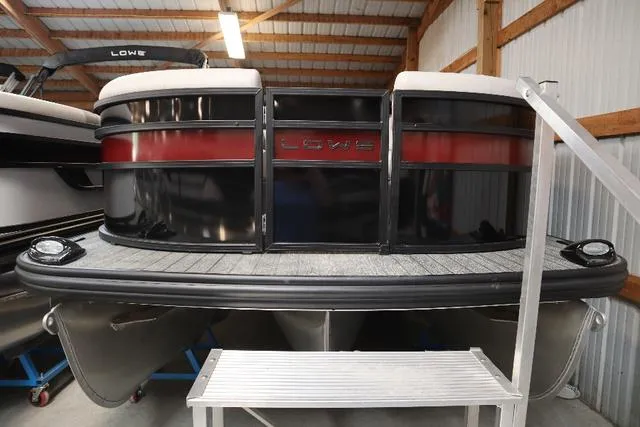 Slide: The Image of 2023 Lowe SS 210 Triple Tube pontoon boat in storage, showcasing sleek design and modern features. - 7