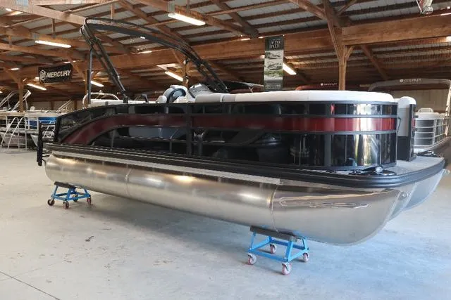 Slide: The Image of 2023 Lowe SS 210 Triple Tube pontoon boat in showroom setting. - 9