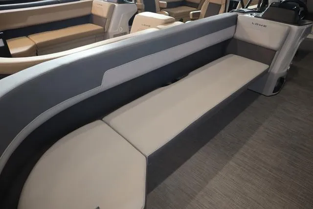 Slide: The Image of 2025 Lowe LS 230 WT Triple Tube Package interior with spacious seating and modern design. - 12