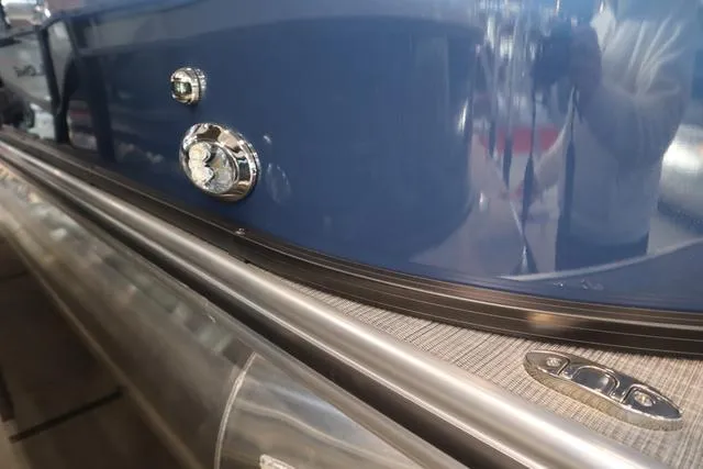 Slide: The Image of 2025 Lowe LS 230 WT Triple Tube Package, close-up of sleek blue exterior and chrome details. - 13