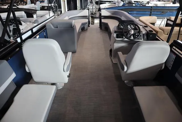 Slide: The Image of 2025 Lowe LS 230 WT Triple Tube Package interior with modern seating and steering console. - 4
