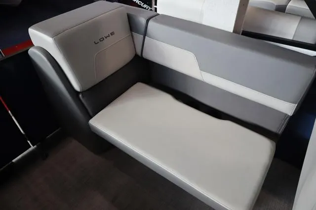 Slide: The Image of 2025 Lowe LS 230 WT Triple Tube Package boat seat, featuring sleek gray and white upholstery. - 5