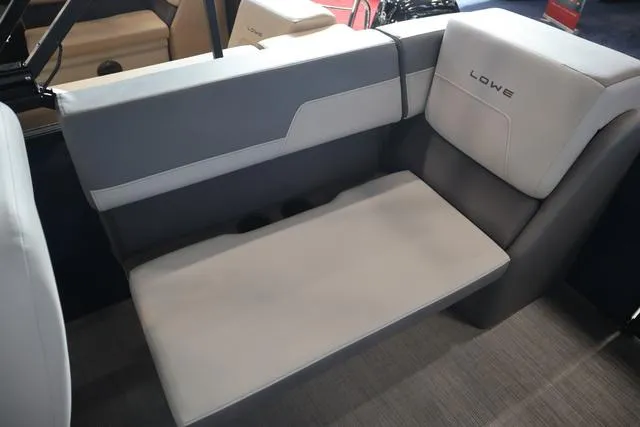 Slide: The Image of 2025 Lowe LS 230 WT Triple Tube Package boat seating, featuring gray and white upholstery. - 6