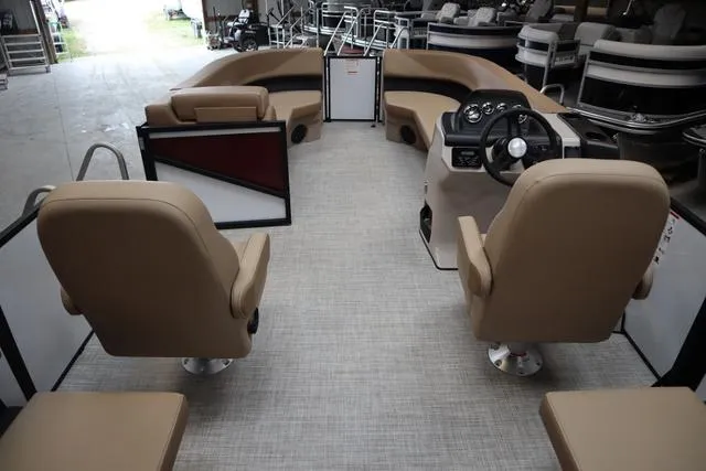 Slide: The Image of 2025 Lowe LS 210 WT boat interior with beige seating and modern dashboard. - 2