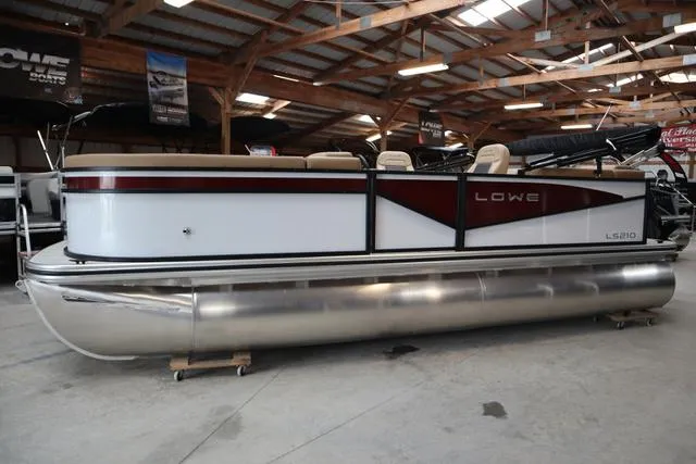 Slide: The Image of 2025 Lowe LS 210 WT pontoon boat in a showroom, side view. - 3
