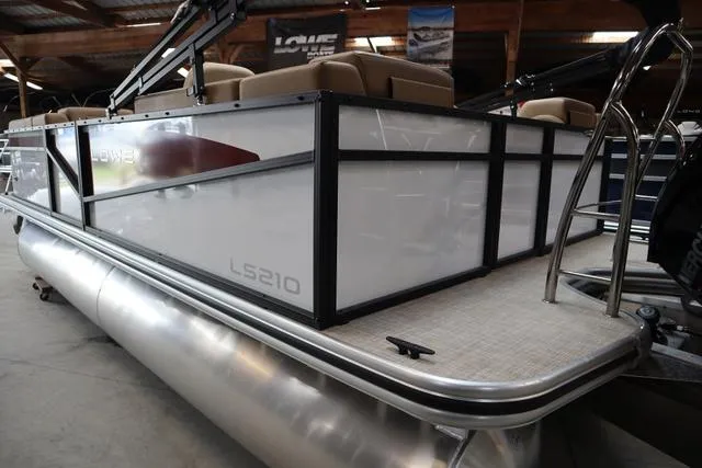 Slide: The Image of 2025 Lowe LS 210 WT pontoon boat in a showroom setting. - 9