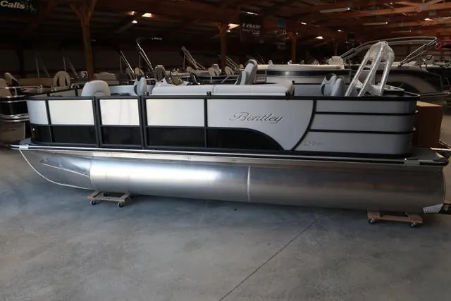 Slide: The Image of 2024 Bentley Pontoons Fish 200 4-Point pontoon boat in a showroom. - 2