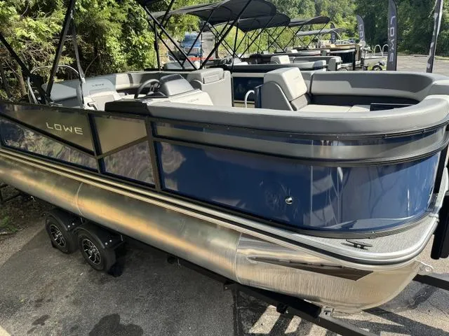 Slide: The Image of 2025 Lowe LS 190 pontoon boat with sleek blue design and comfortable seating. - 3
