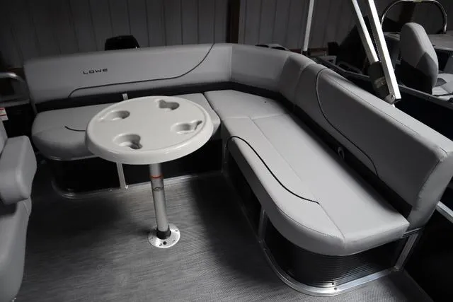 Slide: The Image of 2023 Lowe Ultra Fish 182 boat interior with gray seating and round table. - 4