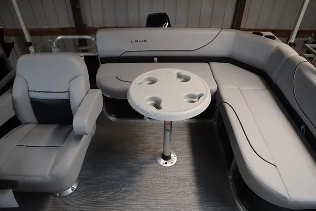 Slide: The Image of 2023 Lowe Ultra Fish 182 boat interior with gray seating and round table. - 6