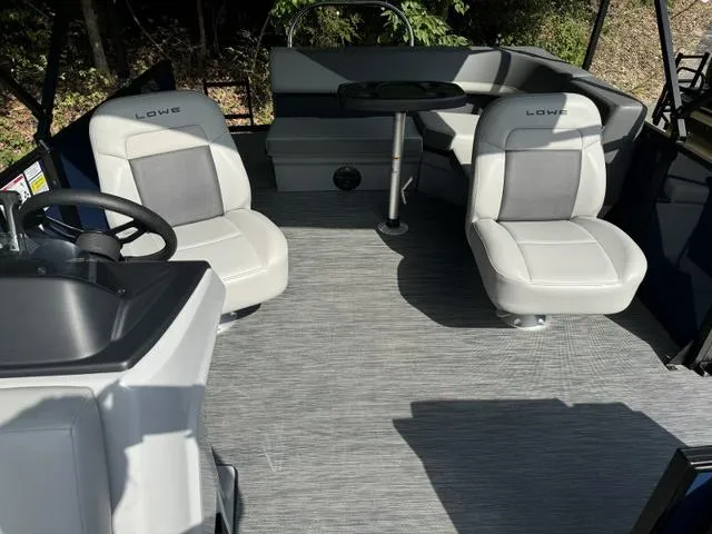 Slide: The Image of 2025 Lowe LS 190 boat interior with gray seating and steering wheel. - 2
