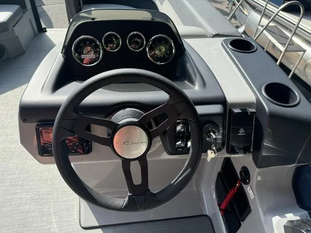 Slide: The Image of Steering wheel and dashboard of 2025 Lowe LS 190 boat, featuring modern controls and gauges. - 3