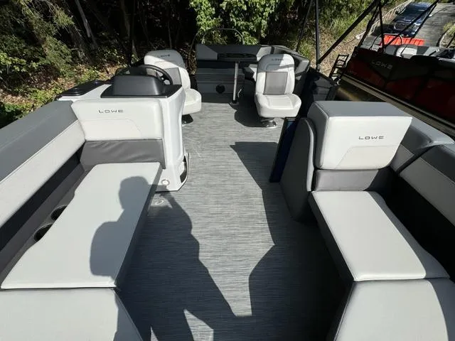 Slide: The Image of 2025 Lowe LS 190 boat interior with gray seating and steering console. - 7