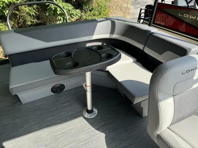 Slide: The Image of 2025 Lowe LS 190 boat interior with gray seating and a central table. - 9