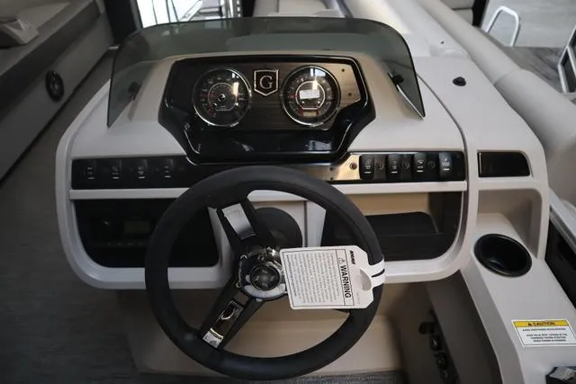 Slide: The Image of 2024 Godfrey Sweetwater 2286 SB boat dashboard with steering wheel and control panel. - 15