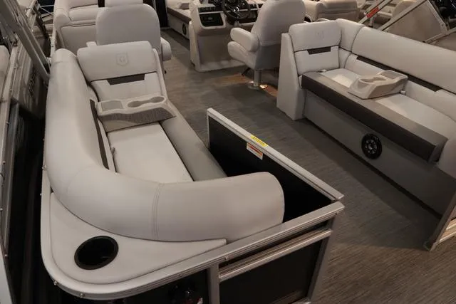 Slide: The Image of 2024 Godfrey Sweetwater 2286 SB Triple Tube Back Porch interior with plush seating and cup holders. - 3