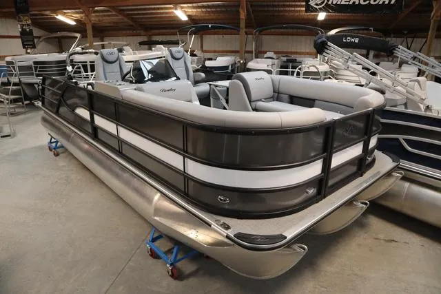 Slide: The Image of 2025 Bentley Pontoons Legacy 223 Swingback Triple Tube in showroom, sleek design, luxury seating. - 1
