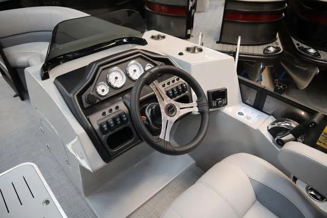Slide: The Image of 2025 Bentley Pontoons Legacy 223 Swingback Triple Tube Pkg dashboard with steering wheel and controls. - 13