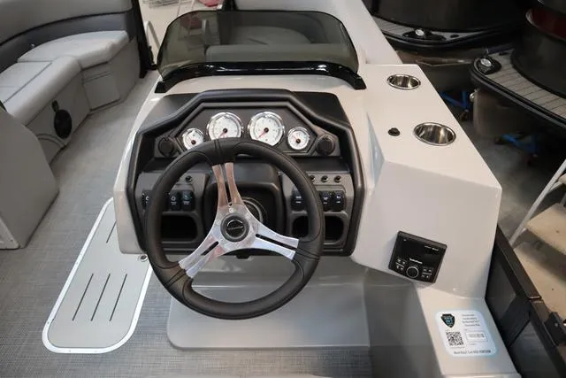 Slide: The Image of 2025 Bentley Pontoons Legacy 223 Swingback dashboard with steering wheel and gauges. - 14