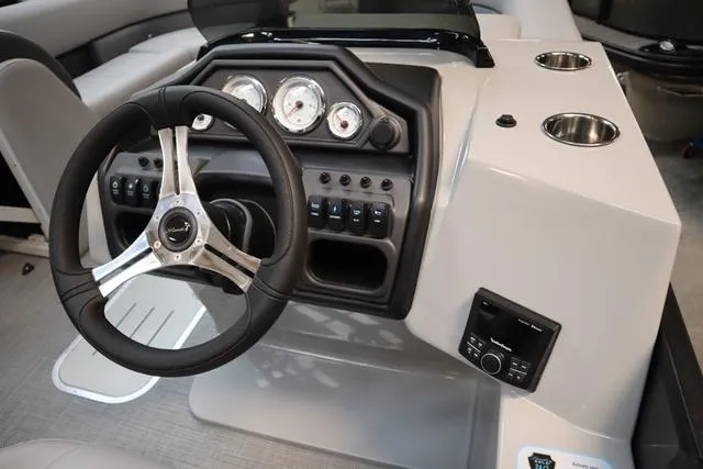 Slide: The Image of 2025 Bentley Pontoons Legacy 223 Swingback dashboard with steering wheel and gauges. - 15