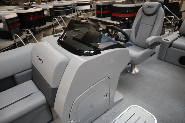 Slide: The Image of 2025 Bentley Pontoons Legacy 223 Swingback Triple Tube interior with sleek helm and seating. - 2