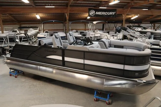 Slide: The Image of 2025 Bentley Pontoons Legacy 223 Swingback Triple Tube in showroom, sleek design, luxury seating. - 3