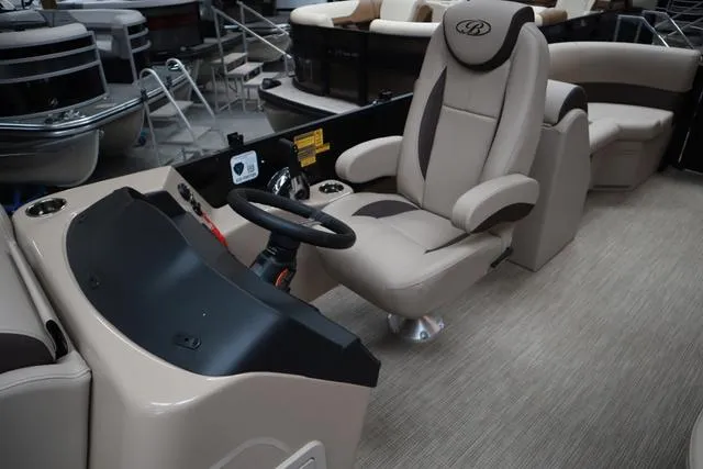 Slide: The Image of 2025 Bentley Pontoons Legacy 223 Navigator Sport Tube interior with captain's chair and steering console. - 5