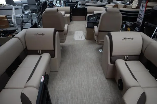 Slide: The Image of 2025 Bentley Pontoons Legacy 223 Navigator Sport Tube interior with beige seating and steering console. - 8