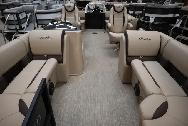 Slide: The Image of 2024 Bentley Pontoons Legacy 220 Navigator interior with luxurious beige seating. - 15