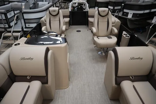 Slide: The Image of 2024 Bentley Pontoons Legacy 220 Navigator interior with beige seating and modern design. - 16