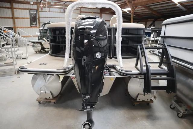 Slide: The Image of 2024 Bentley Pontoons Legacy 220 Navigator in a showroom, rear view with motor. - 19