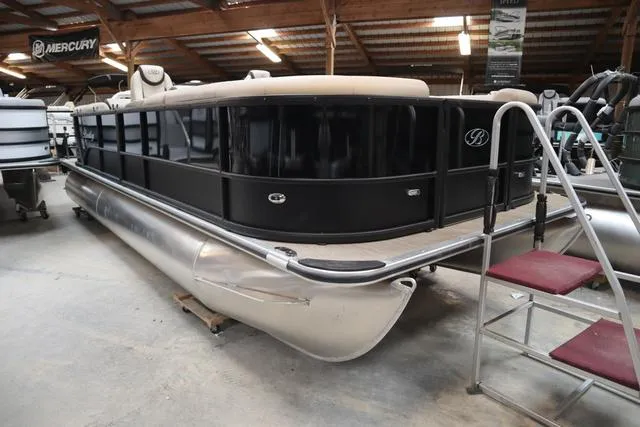 Slide: The Image of 2024 Bentley Pontoons Legacy 220 Navigator in storage, showcasing sleek design and spacious seating. - 3