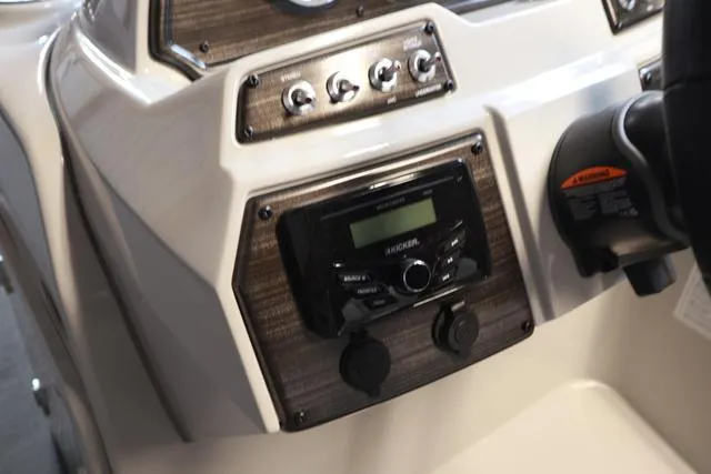 Slide: The Image of Control panel of 2025 Lowe SS 230 WV boat with audio system and switches. - 11