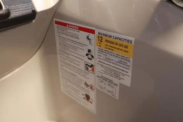 Slide: The Image of Safety and capacity labels on 2025 Lowe SS 230 WV Special Triple Tube Package boat. - 12